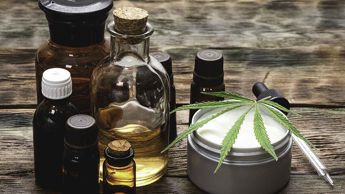 CBD products in glass jars on a wooden table