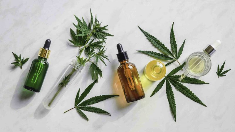 Many types of cbd products laying next to each other on a white surface