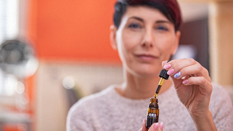 a women taking cbd oil