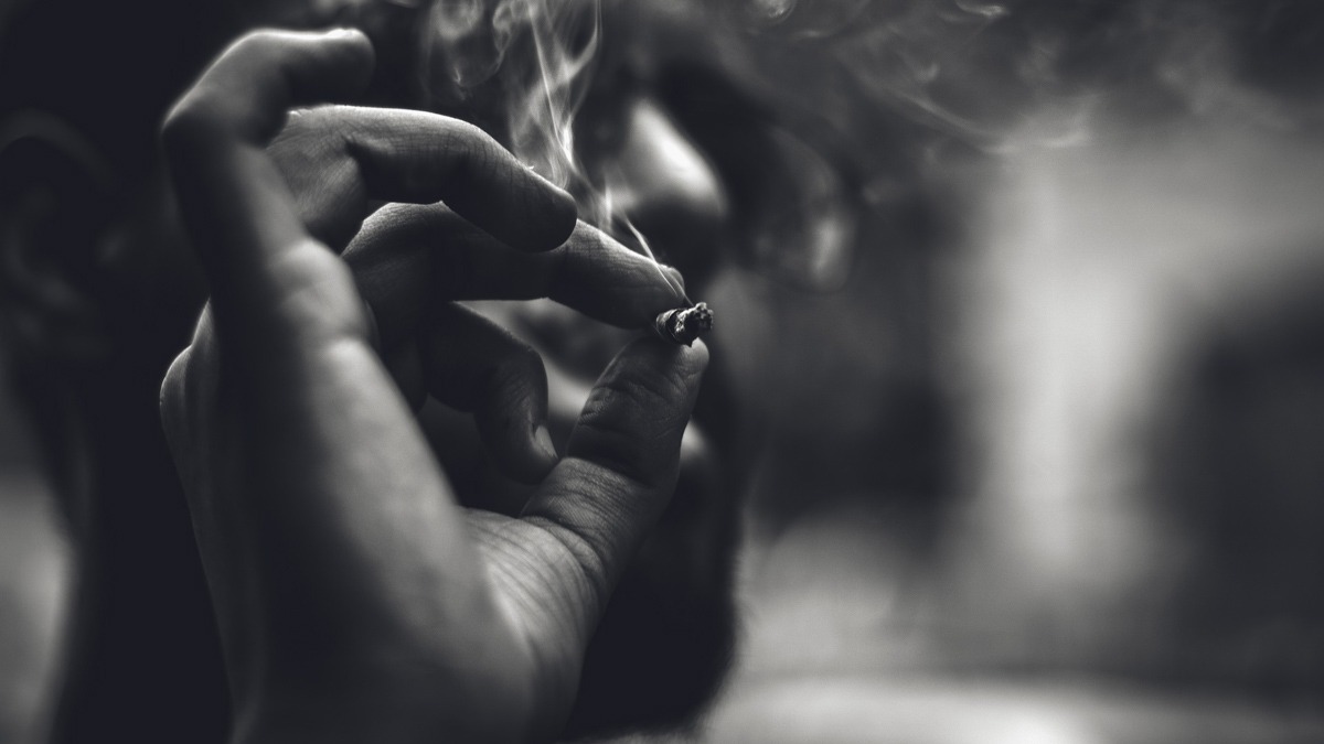 a guy is smoking, black and white photo, cbd and nicotine banner