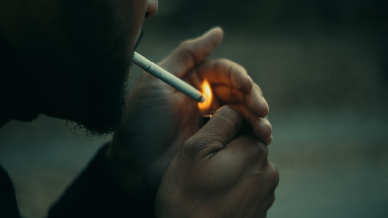 a guy is smoking in the dark