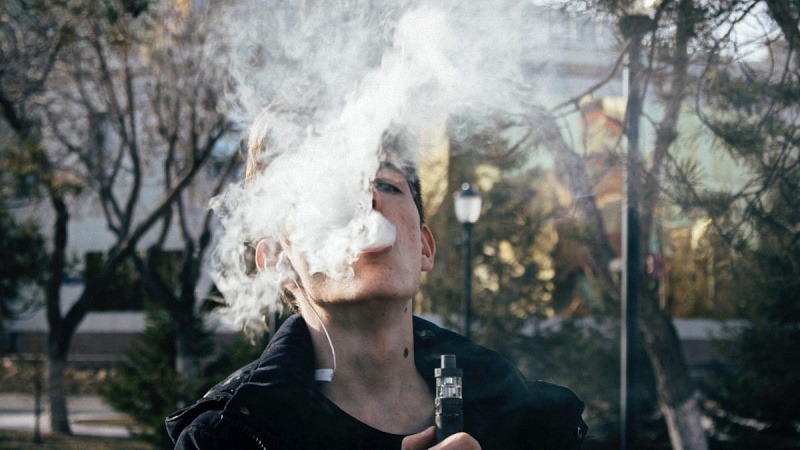 Man Smoking Under the Trees