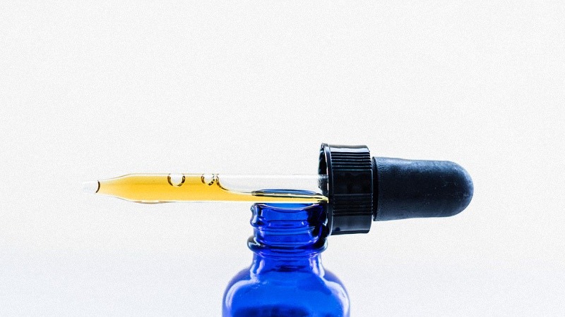 CBD Oil Dropper on Top of Bottle