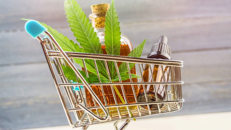 supermarket trolley with marijuana leaf and CBD oil