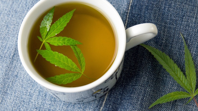 Cup of Tea With Hemp Leaf Denim Background