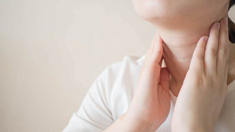 Woman checking herself for hypothyroidism